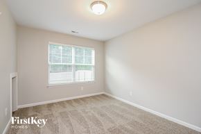 Winston Salem house for rent - a spacious room with carpet and a large window