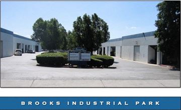 Orange apartment for rent - A sign in front of a building that says Brooks Industrial Park.