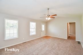 Dallas house for rent - a living room with carpet and a ceiling fan