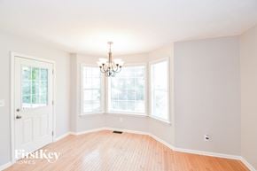 Dallas house for rent - a dining room with a chandelier and three windows