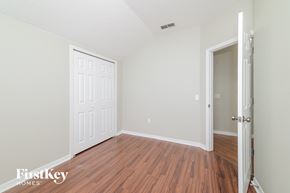 Haines City house for rent - a bedroom with wood flooring and a white door