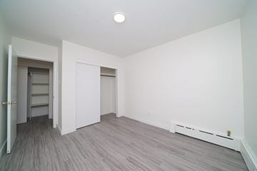 Winnipeg apartment for rent - a living room with white walls and wood floors and a closet