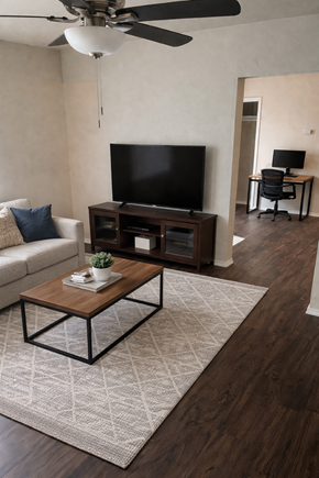 Kaufman apartment for rent - A living room with a television, a couch, a coffee table, and a ceiling fan.