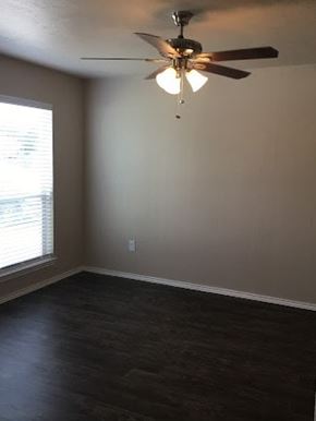 Kaufman apartment for rent - A room with a ceiling fan and a window.