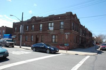 Brooklyn apartment for rent - an old brick building on the corner of a city street