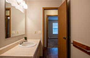 Wayland apartment for rent - A bathroom with a white sink and a mirror.