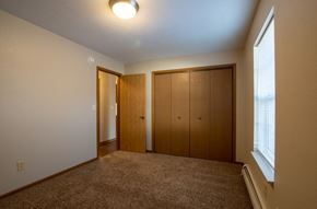 Wayland apartment for rent - A room with a carpeted floor and a window with blinds.
