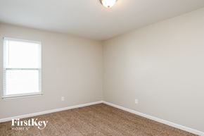 Statesville house for rent - a bedroom with white walls and carpet and a window