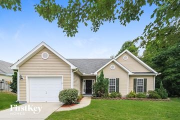 Winston-Salem house for rent - a beige house with a white garage door