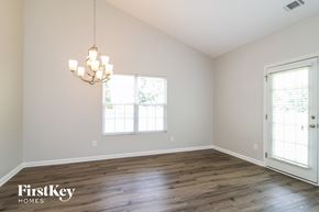 Winston-Salem house for rent - an empty living room with wood floors and a chandelier