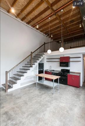 Detroit apartment for rent - a kitchen with a table and a staircase in a loft