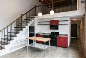 Detroit apartment for rent - a small kitchen under a staircase in a house