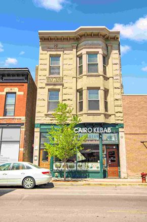 Chicago apartment for rent - a white car parked in front of a building on a city street