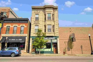 Chicago apartment for rent - a car parked in front of a building on a city street