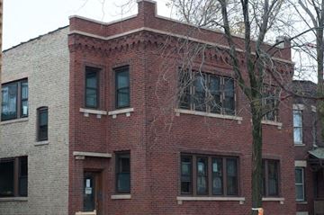 Chicago apartment for rent - a brick building with a tree in front of it