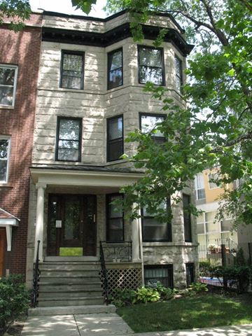 Chicago apartment for rent - a brick house with a front porch and stairs
