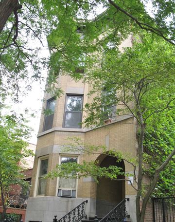 Chicago apartment for rent - a tall building with trees in front of it
