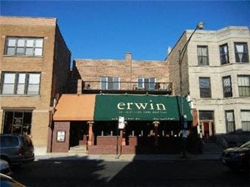 Chicago apartment for rent - a building with a green sign on the front of it