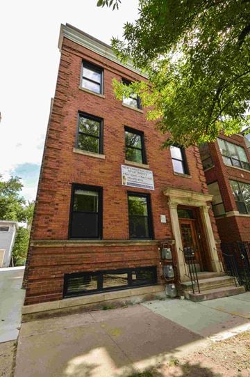 Chicago apartment for rent - a red brick building with a sign on the side of it
