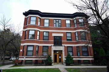 Chicago apartment for rent - a large brick building with a sidewalk in front of it