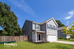 Johns Island house for rent - A grey house with the words "FirstKey Homes" on the lawn.