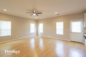 Johns Island house for rent - A spacious room with wooden floors and a ceiling fan.