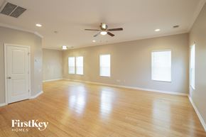 Johns Island house for rent - A spacious room with wooden floors and a ceiling fan.