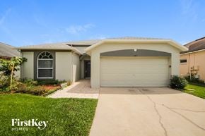 Orlando house for rent - a home with a white garage door and a driveway