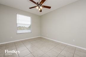 Orlando house for rent - a living room with a ceiling fan and a tiled floor