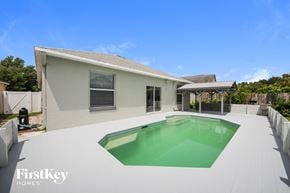 Orlando house for rent - a backyard with a pool and a house