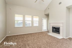 Royse City house for rent - the living room has a fireplace and carpeted flooring