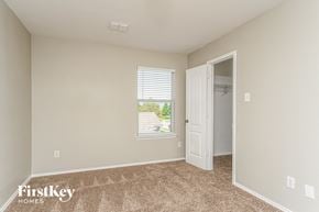 Royse City house for rent - a bedroom with a door to a closet and a window