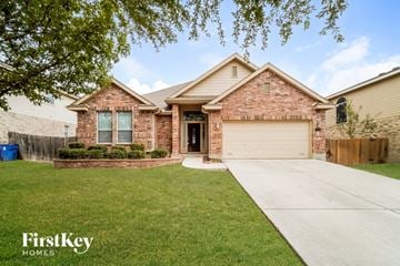 Cibolo house for rent - a brick house with a driveway and a garage door