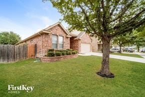 Cibolo house for rent - a house with a yard and a tree in front of it