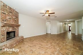 Cibolo house for rent - a living room with a brick fireplace and a ceiling fan