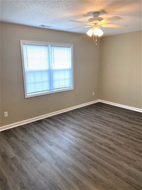 Hubert house for rent - A room with a window and a ceiling fan.