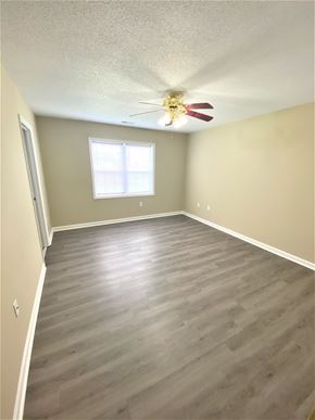 Hubert house for rent - A room with a ceiling fan and a window.