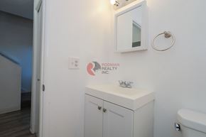 Longview apartment for rent - A bathroom with a toilet, sink, and a mirror on the wall.