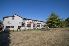 Longview apartment for rent - A large white building with a red sign on the side.