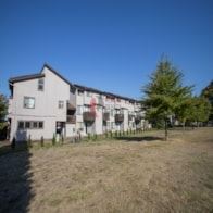 Longview apartment for rent - A white building with a red logo on it.