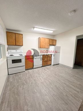 Longview apartment for rent - A room with a white stove and wooden cabinets.