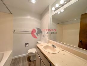 Longview apartment for rent - A bathroom with a sink, toilet, and mirror.