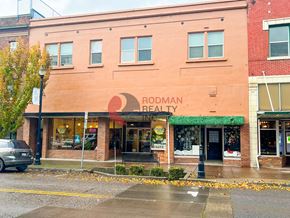Longview apartment for rent - Rodman Realty is a brick building with a green awning.