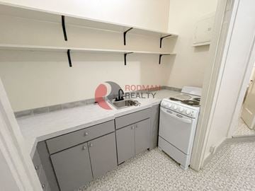 Longview apartment for rent - A small kitchen with a stove and a sink.