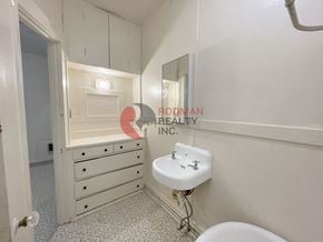 Longview apartment for rent - A bathroom with a sink, toilet, and a mirror.