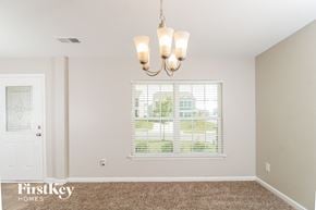 Whitsett house for rent - the living room of a home with a window and a chandelier