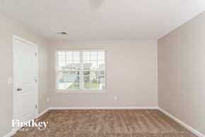 Whitsett house for rent - a bedroom with carpet and a window