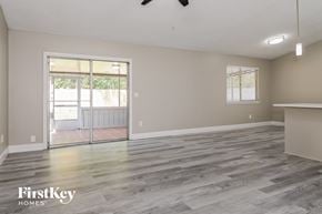 Jacksonville house for rent - the living room and dining room with wood flooring and a sliding glass door