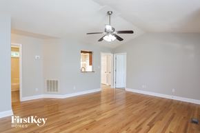 Durham house for rent - the living room and dining room with hardwood flooring and a ceiling fan