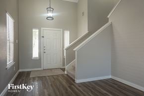 Cypress house for rent - the entryway of a home with a staircase and a white door